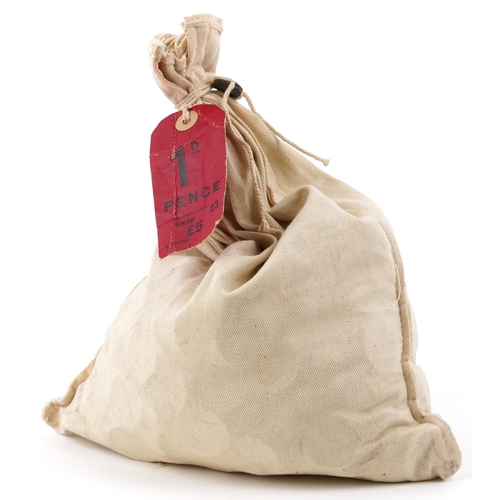 1193 - A sealed 1960s bank bag containing five pounds in pre decimal one pence pieces, the bag with origina... 