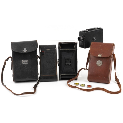 1061 - A Ciné-Kodak model BB Junior camera, cased, together with a folding camera within a brown leather ca... 