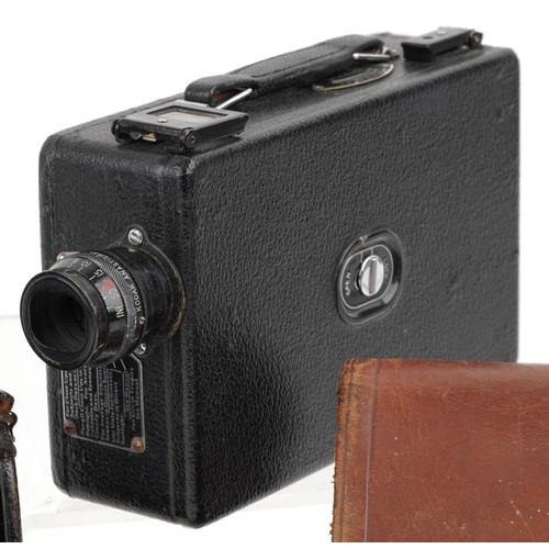 1061 - A Ciné-Kodak model BB Junior camera, cased, together with a folding camera within a brown leather ca... 