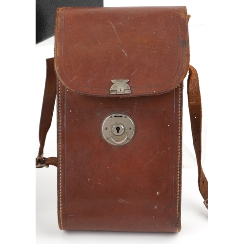 1061 - A Ciné-Kodak model BB Junior camera, cased, together with a folding camera within a brown leather ca... 