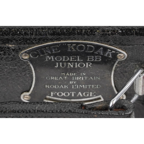 1061 - A Ciné-Kodak model BB Junior camera, cased, together with a folding camera within a brown leather ca... 