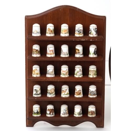668 - Collectable porcelain thimbles with display stands including The Garden Birds Thimble Collection and... 