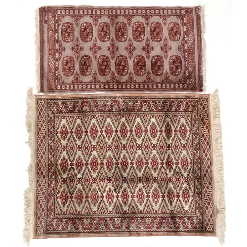 2206 - A Pakistan Bokhara rug, 20th century, the grey field with two columns of guls within a complementary... 