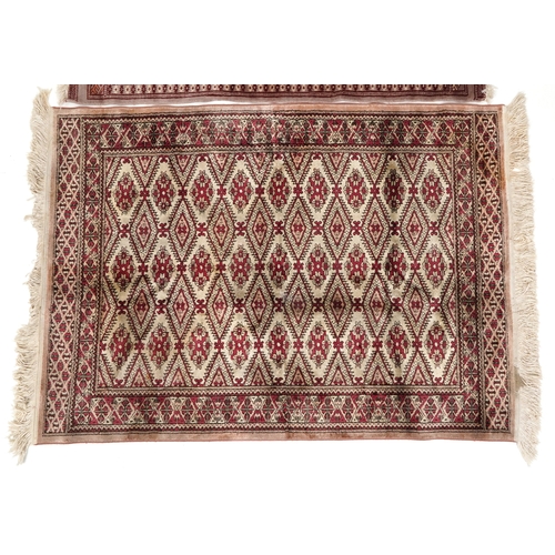 2206 - A Pakistan Bokhara rug, 20th century, the grey field with two columns of guls within a complementary... 