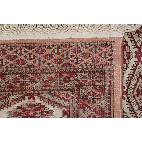 2206 - A Pakistan Bokhara rug, 20th century, the grey field with two columns of guls within a complementary... 