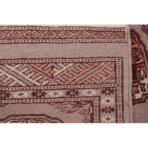 2206 - A Pakistan Bokhara rug, 20th century, the grey field with two columns of guls within a complementary... 