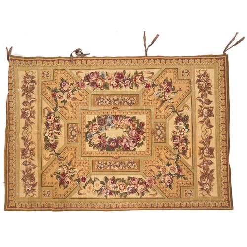 1673A - A 20th century tapestry wall hanging decorated with roses within a leaf border, 120cm x 175cm.