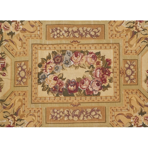 1673A - A 20th century tapestry wall hanging decorated with roses within a leaf border, 120cm x 175cm.