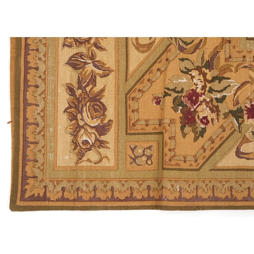 1673A - A 20th century tapestry wall hanging decorated with roses within a leaf border, 120cm x 175cm.