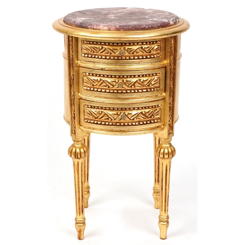 2137 - A modern gilt painted bedside chest of three drawers with a rouge marble top, raised on fluted legs ... 