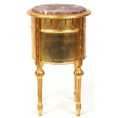 2137 - A modern gilt painted bedside chest of three drawers with a rouge marble top, raised on fluted legs ... 