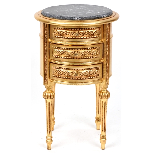 2136 - A modern gilt painted bedside chest of three drawers with a black marble top, raised on fluted legs ... 