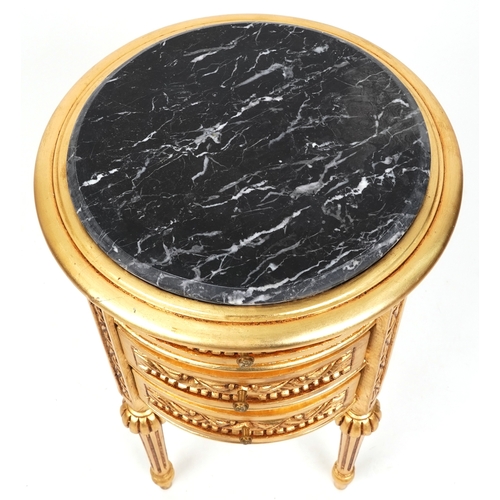 2136 - A modern gilt painted bedside chest of three drawers with a black marble top, raised on fluted legs ... 
