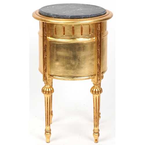 2136 - A modern gilt painted bedside chest of three drawers with a black marble top, raised on fluted legs ... 