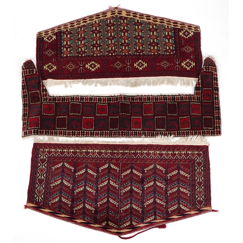 2202 - Three Turkmen door hangings, late 20th century, each with typical red field and stylized motifs, the... 