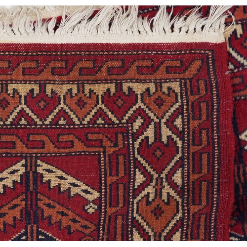 2202 - Three Turkmen door hangings, late 20th century, each with typical red field and stylized motifs, the... 
