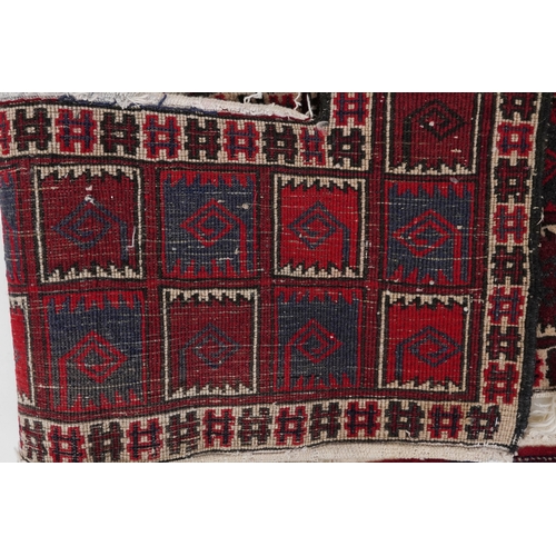 2202 - Three Turkmen door hangings, late 20th century, each with typical red field and stylized motifs, the... 