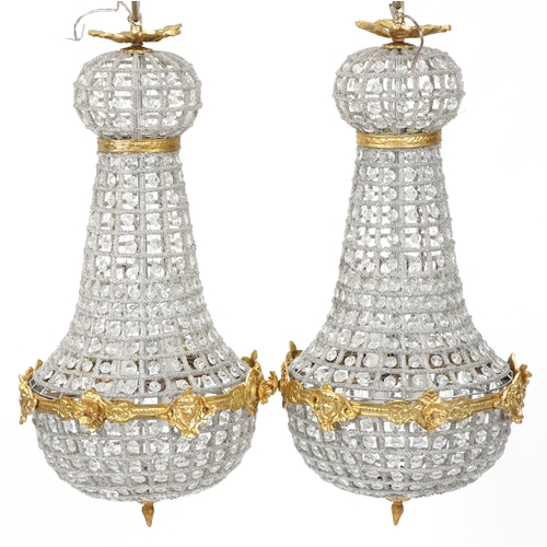 2170 - A pair of gilt metal and cut glass ceiling lights, 68cm high.