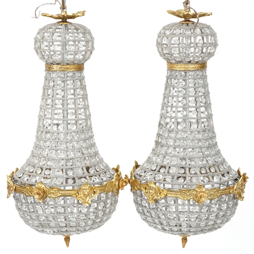 2170 - A pair of gilt metal and cut glass ceiling lights, 68cm high.