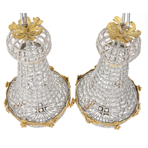 2170 - A pair of gilt metal and cut glass ceiling lights, 68cm high.