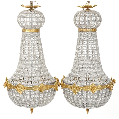 2170 - A pair of gilt metal and cut glass ceiling lights, 68cm high.