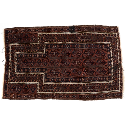 2211 - A Baluch prayer rug, 20th century, the brown field with an asymmetrical central panel within a flowe... 