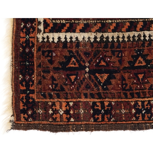 2211 - A Baluch prayer rug, 20th century, the brown field with an asymmetrical central panel within a flowe... 