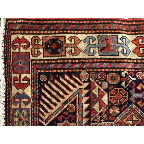 2209 - A Caucasian runner, 20th century, the blue field with four stylized flower head motifs within a comp... 