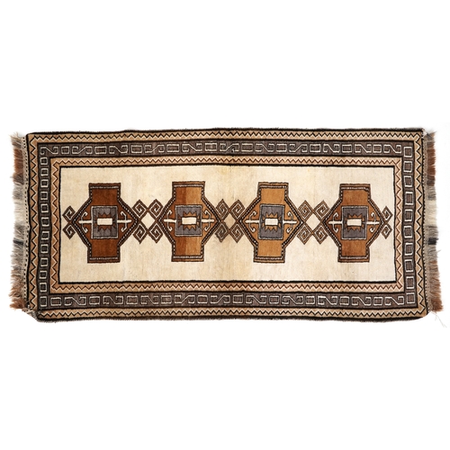 2203 - A Persian runner, the ivory field with four central medallions within a grey border, 212cm x 102cm.