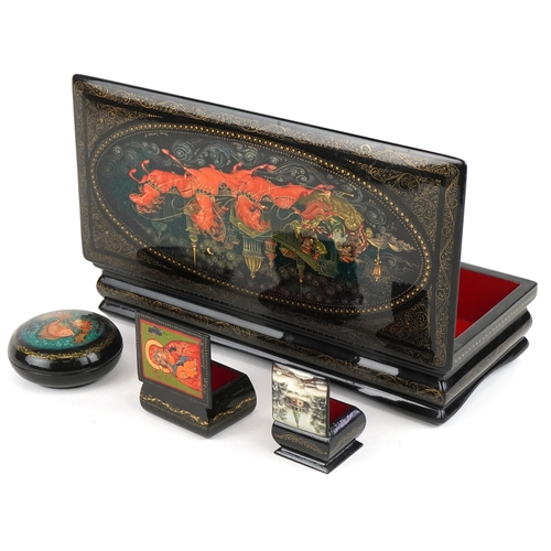 1570 - Four Russian lacquered papier mâché boxes, each hand painted with traditional folk art, the largest ... 