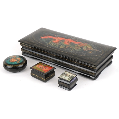 1570 - Four Russian lacquered papier mâché boxes, each hand painted with traditional folk art, the largest ... 