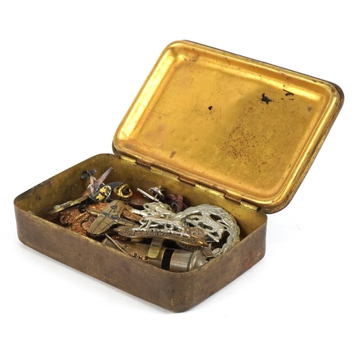 2826 - British militaria including a Christmas 1914 Mary tin, cap badges and a Metropolitan Police whistle.