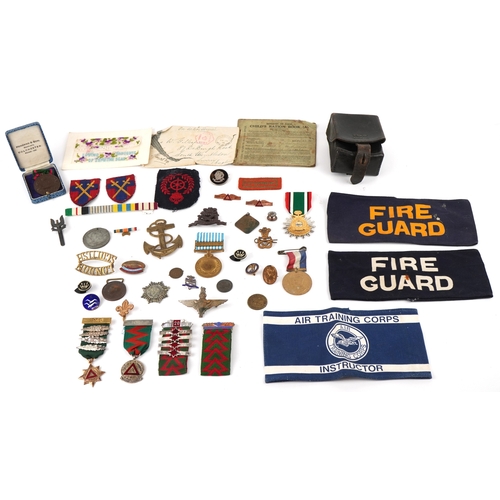 2818 - A collection of military interest medals, driving awards, cap badges and commemorative medals includ... 
