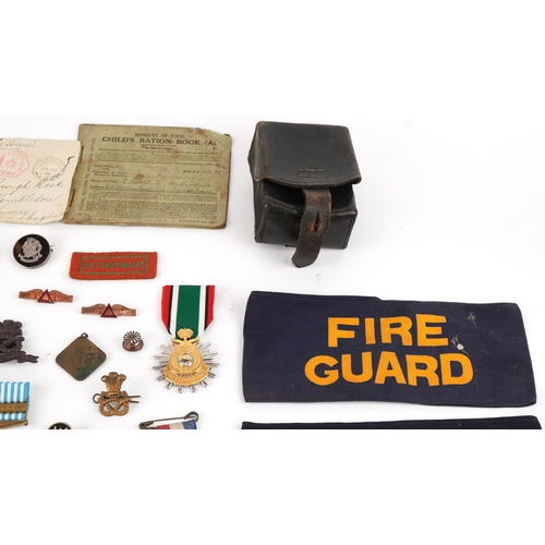 2818 - A collection of military interest medals, driving awards, cap badges and commemorative medals includ... 
