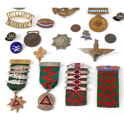 2818 - A collection of military interest medals, driving awards, cap badges and commemorative medals includ... 