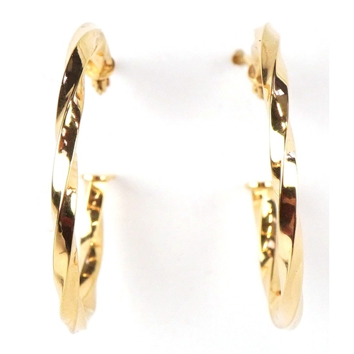 3256 - A pair of as new 9ct gold twisted hoop earrings  retailed by Goldsmiths, with box, 2.3cm in diameter... 