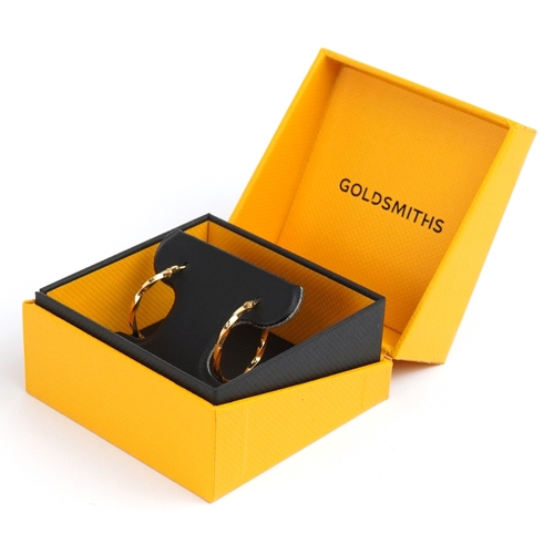 3256 - A pair of as new 9ct gold twisted hoop earrings  retailed by Goldsmiths, with box, 2.3cm in diameter... 