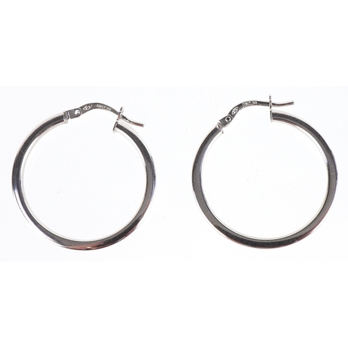 3096 - A pair of as new 9ct white gold hoop earrings retailed by Goldsmiths, with box, 2.6cm in diameter, t... 