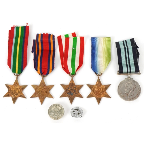 2694 - Five British military World War II medals and two cap badges including the Italy Star, the Pacific S... 
