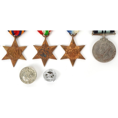 2694 - Five British military World War II medals and two cap badges including the Italy Star, the Pacific S... 