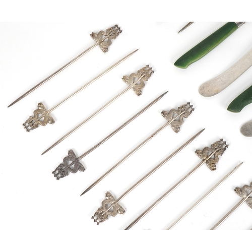 1865 - Five antique silver bladed butter knives and seventeen silver plated skewers in the form of mythical... 