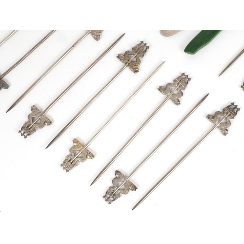 1865 - Five antique silver bladed butter knives and seventeen silver plated skewers in the form of mythical... 