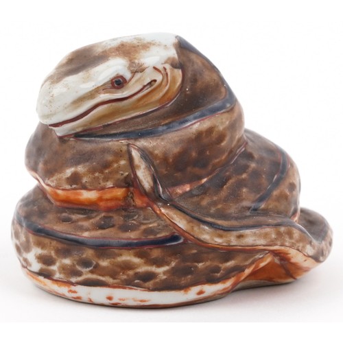329A - In the manner of Martin Brothers, a studio pottery study of a coiled serpent, signed and dated 1887,... 