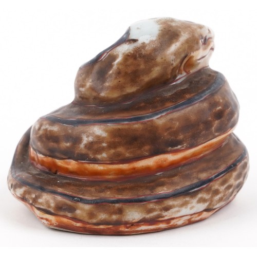 329A - In the manner of Martin Brothers, a studio pottery study of a coiled serpent, signed and dated 1887,... 