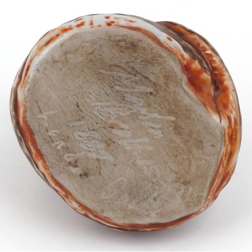 329A - In the manner of Martin Brothers, a studio pottery study of a coiled serpent, signed and dated 1887,... 