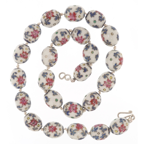 3087 - A Chinese porcelain bead necklace with hand painted floral decoration and a silver clasp, 49cm in le... 