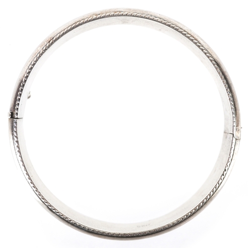 3225 - A silver hinged bangle, 6.8cm in diameter, 20.4g.