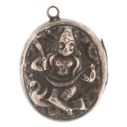 3381 - An Indian unmarked silver locket decorated in repoussé with a deity, 3cm high, 13.9g.