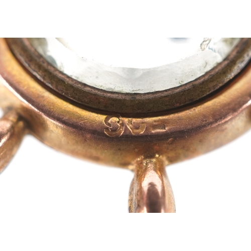 3250 - A 9ct gold compass charm in the form of a ship's wheel, 2.5cm in diameter, 2.9g.