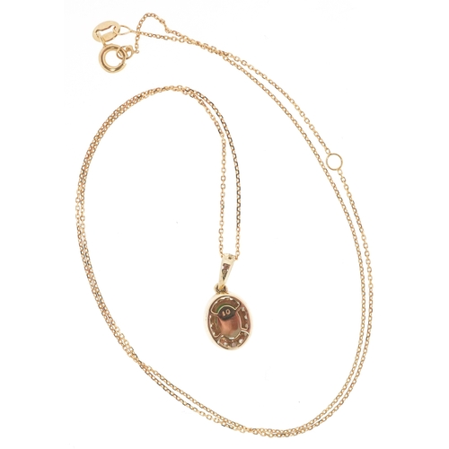 3206 - A 9K gold emerald and diamond cluster pendant on a 9K gold necklace, total diamond weight 0.19 carat... 